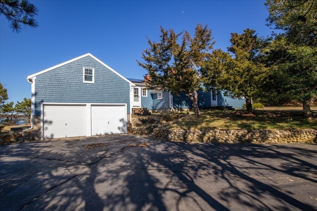 157 Daniels Island Road Mashpee, MA 02649 - Photo 4 of 41 a front view of a house with a yard