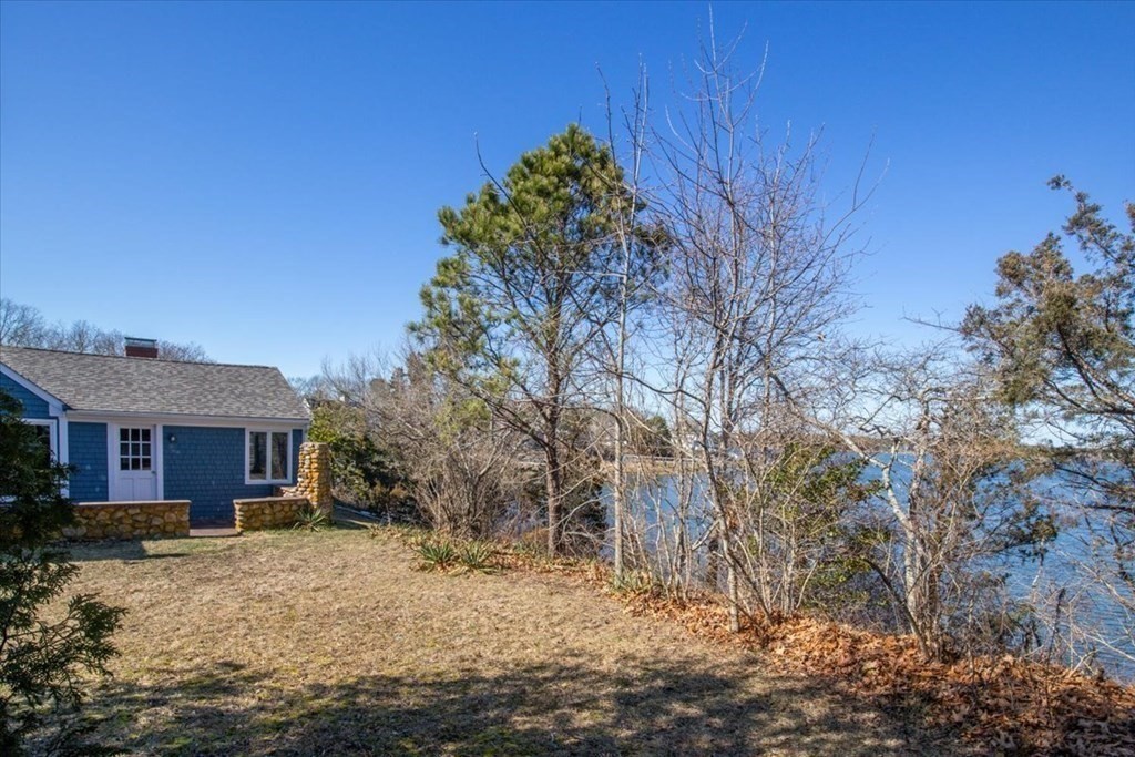 157 Daniels Island Road Mashpee, MA 02649 - Photo 6 of 41 a front view of a house with a yard