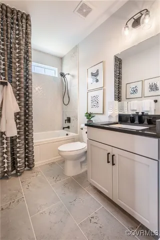 a bathroom with a granite countertop sink a toilet a mirror and shower