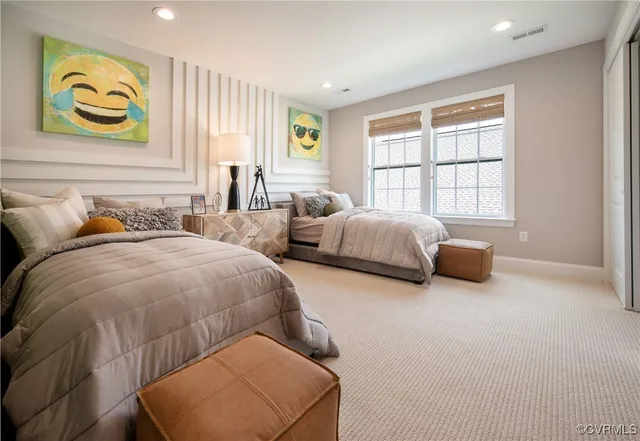 a spacious bedroom with two beds and a large window