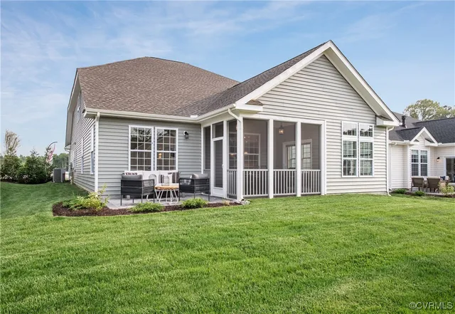 a view of a house with a yard and sitting area