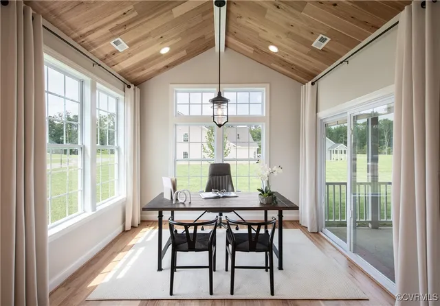 a dining room with furniture a chandelier and wooden floor