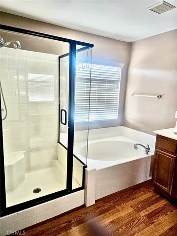 a bathroom with a bathtub and a shower