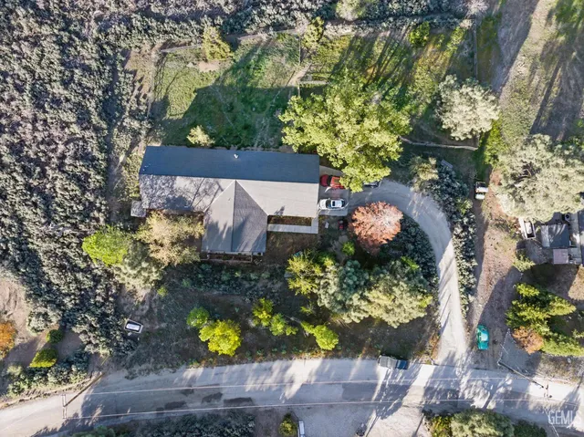 an aerial view of a house with a yard and garden