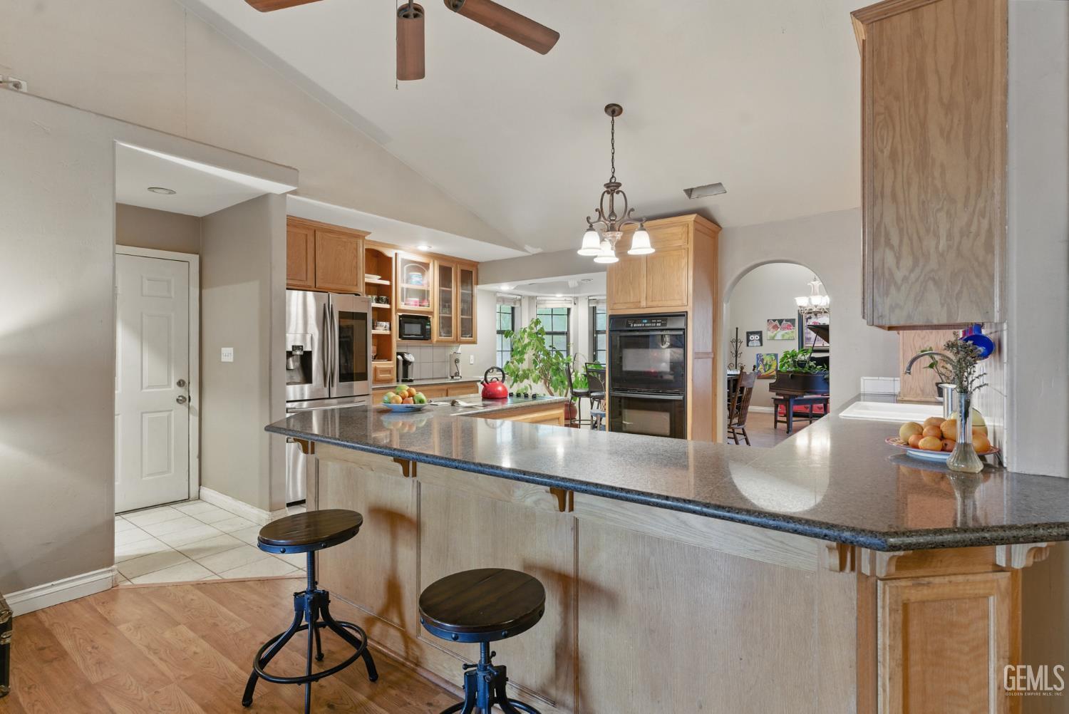 Undisclosed Address Tehachapi, CA 93561 - Photo 21 of 40 a kitchen with stainless steel appliances granite countertop a sink and a refrigerator