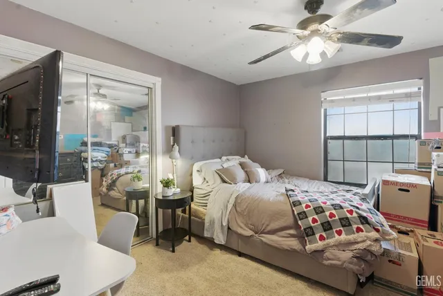 a bedroom with a bed and a chandelier