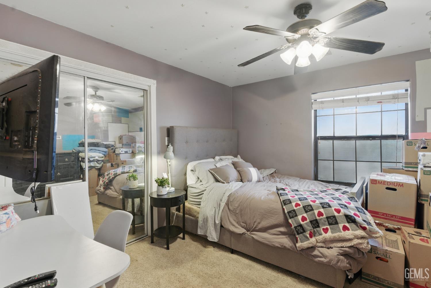 Undisclosed Address Tehachapi, CA 93561 - Photo 27 of 40 a bedroom with a bed and a chandelier