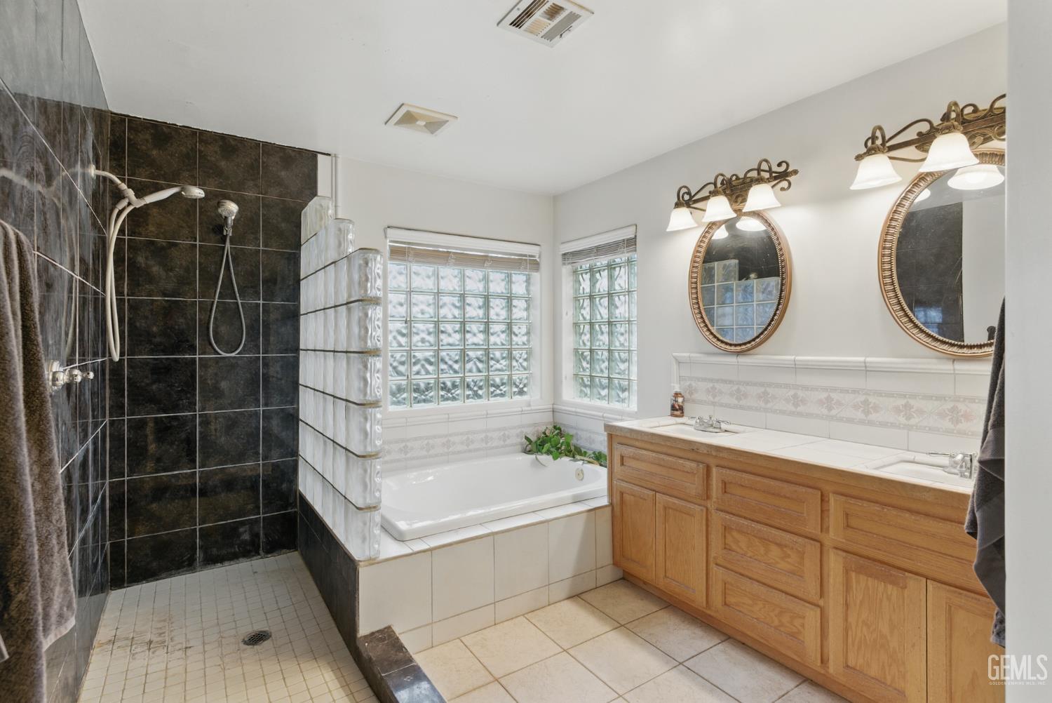 Undisclosed Address Tehachapi, CA 93561 - Photo 30 of 40 a bathroom with a bathtub a sink and a mirror