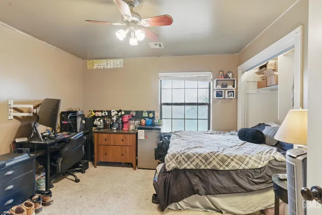 a backyard of a house with barbeque oven and outdoor seating