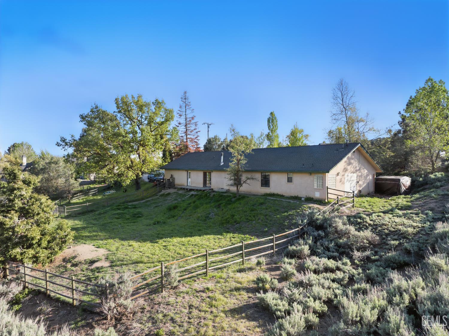 Undisclosed Address Tehachapi, CA 93561 - Photo 10 of 40 a view of a house with a yard