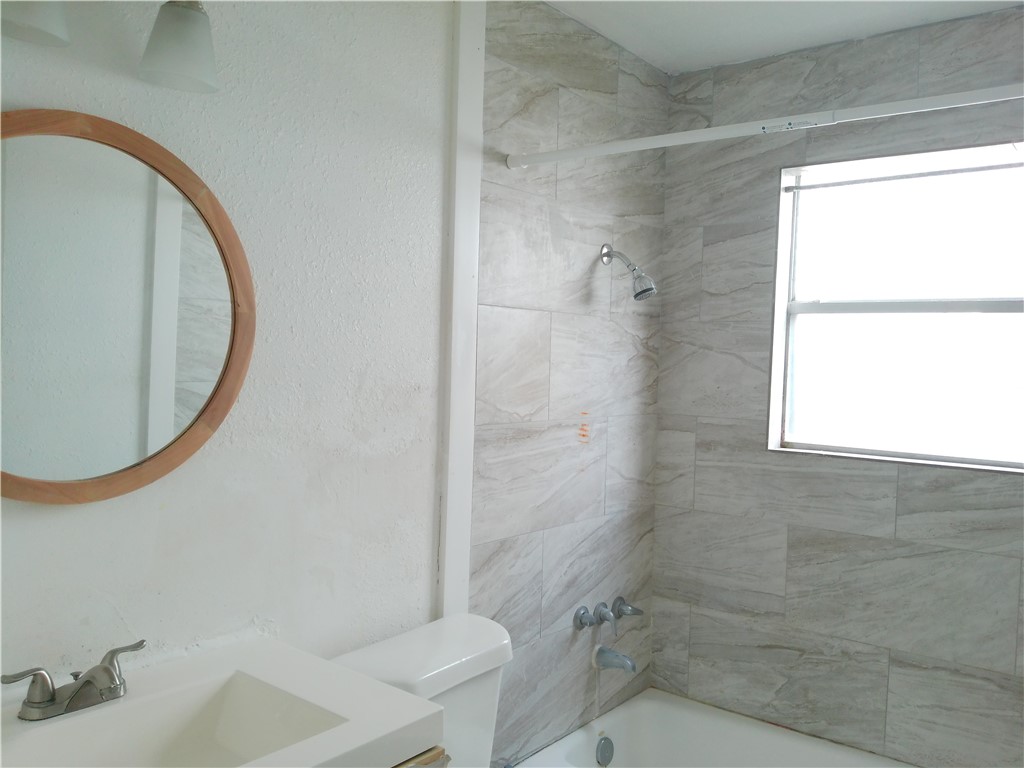 829 Indiana Avenue, Unit 2 Corpus Christi, TX 78404 - Photo 12 of 12 a bathroom with a sink and a mirror
