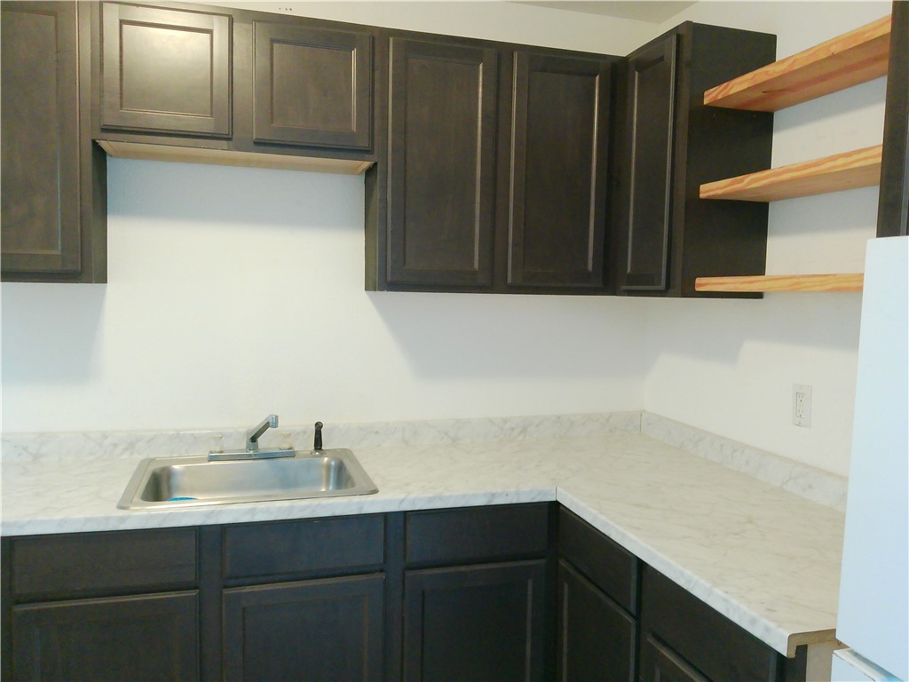 829 Indiana Avenue, Unit 2 Corpus Christi, TX 78404 - Photo 5 of 12 a bathroom with a sink and a mirror