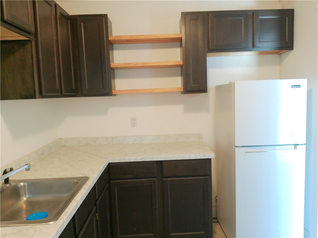 829 Indiana Avenue, Unit 2 Corpus Christi, TX 78404 - Photo 6 of 12 a kitchen with a refrigerator and a sink