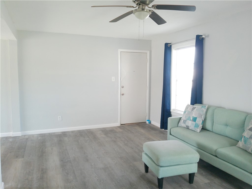 829 Indiana Avenue, Unit 2 Corpus Christi, TX 78404 - Photo 9 of 12 a living room with furniture and a window