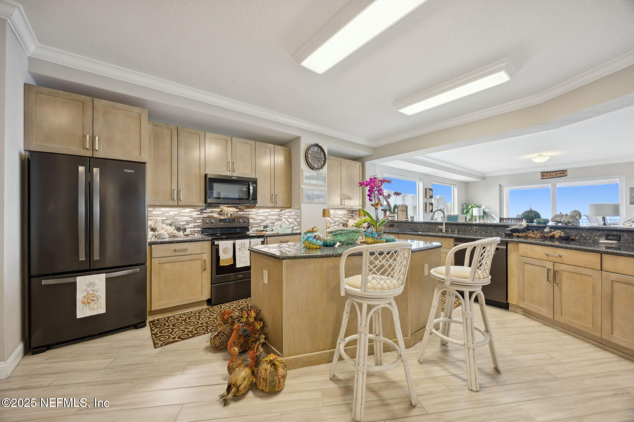 60 Surfview Drive, Unit 801 Palm Coast, FL 32137 - Photo 12 of 64 a kitchen with stainless steel appliances granite countertop a refrigerator and a stove top oven