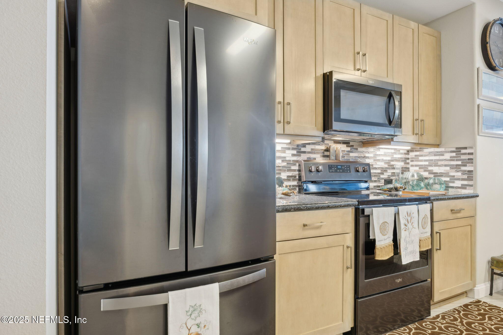 60 Surfview Drive, Unit 801 Palm Coast, FL 32137 - Photo 15 of 64 a kitchen with stainless steel appliances granite countertop a refrigerator and a stove top oven