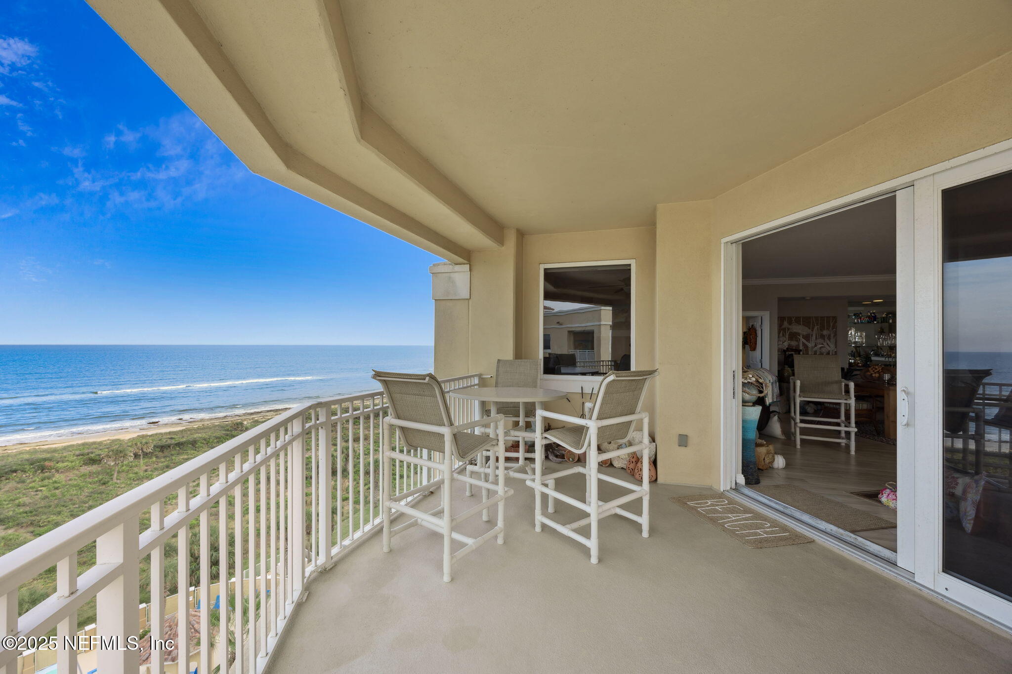 60 Surfview Drive, Unit 801 Palm Coast, FL 32137 - Photo 19 of 64 a view of a balcony with chairs and table