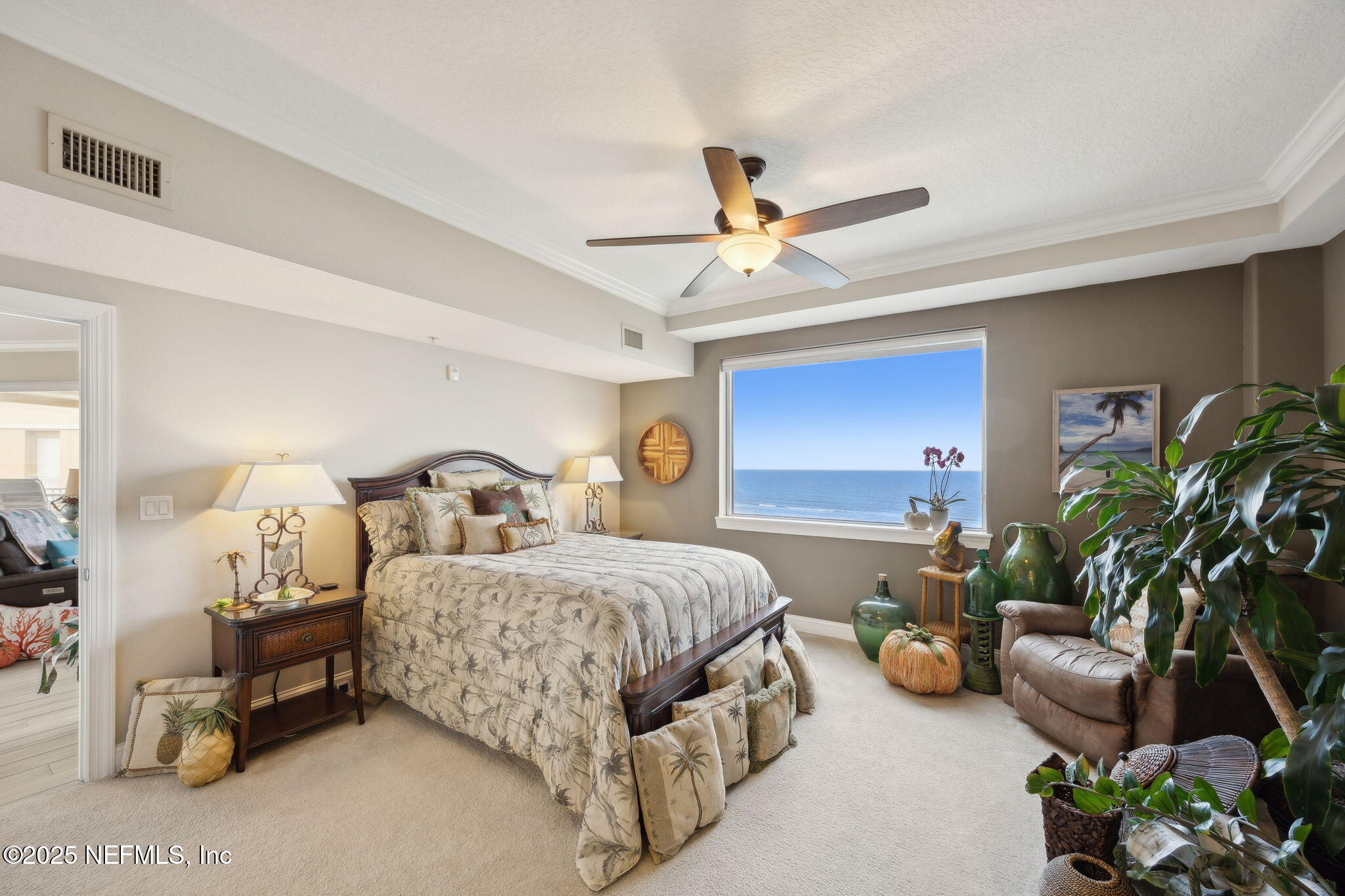 60 Surfview Drive, Unit 801 Palm Coast, FL 32137 - Photo 23 of 64 a bedroom with a bed a couch and a potted plant on the dresser