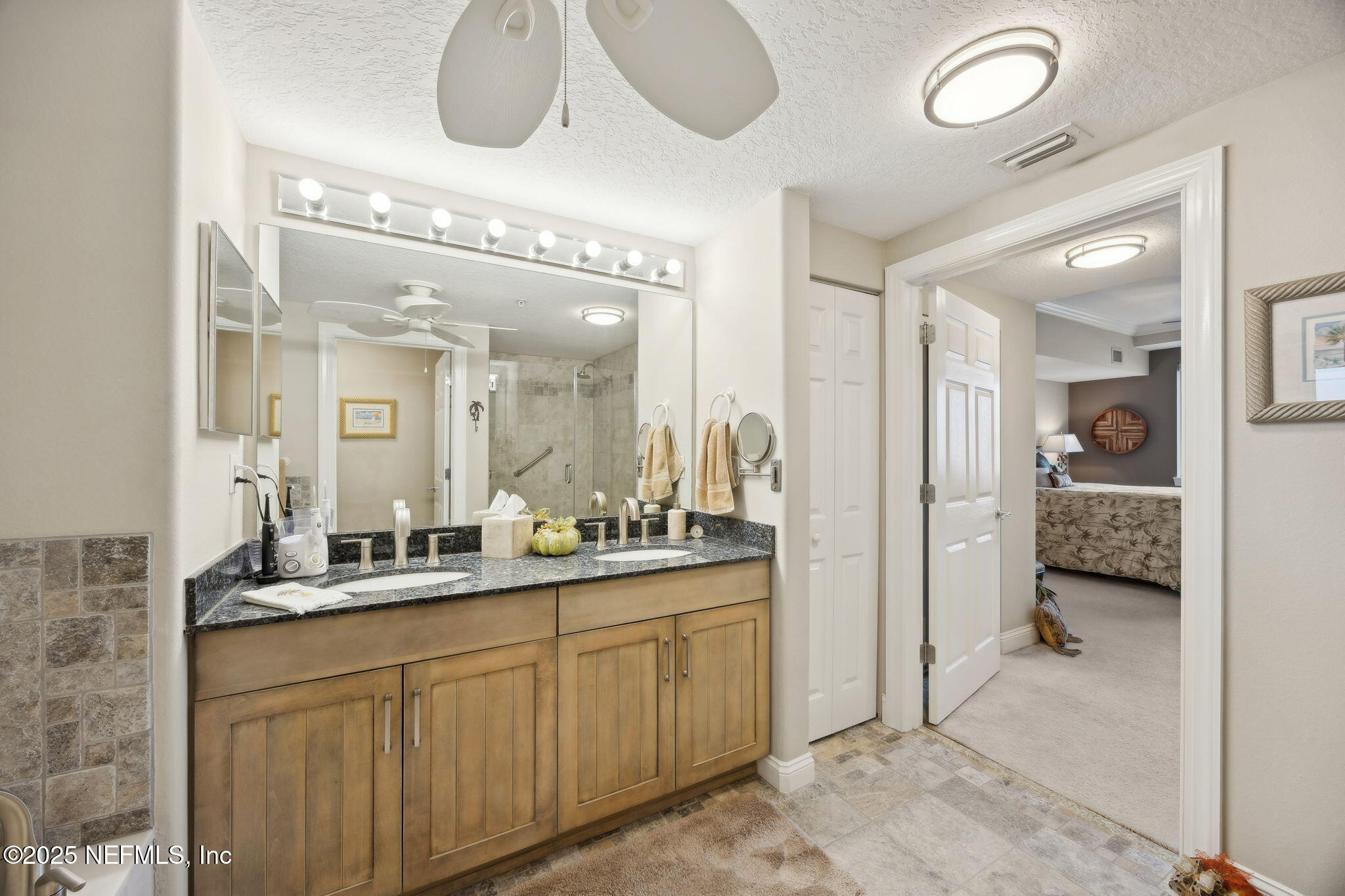 60 Surfview Drive, Unit 801 Palm Coast, FL 32137 - Photo 25 of 64 a en suite bathroom with a double vanity sink and a mirror