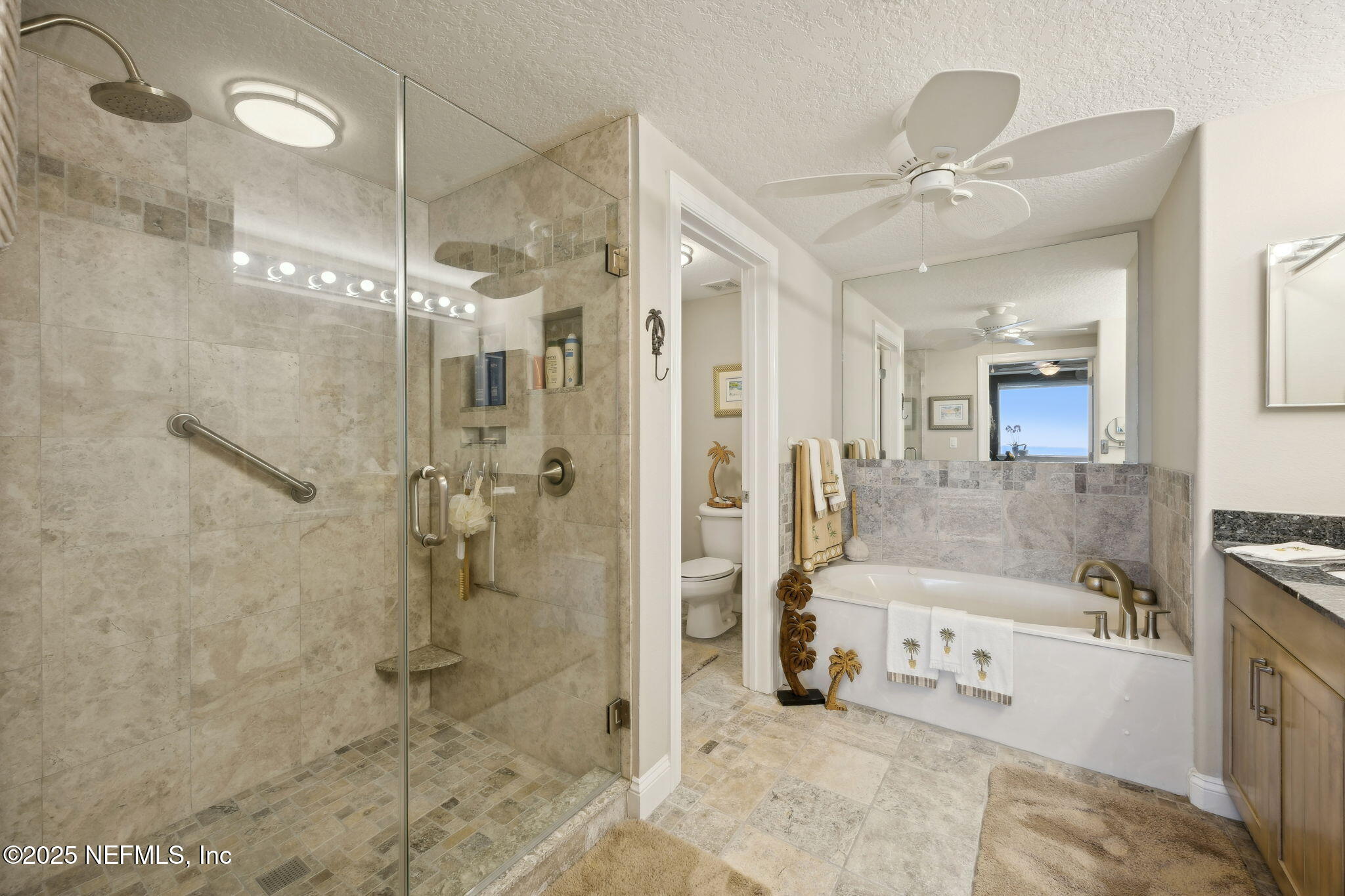 60 Surfview Drive, Unit 801 Palm Coast, FL 32137 - Photo 26 of 64 a large spacious bathroom with a glass shower door and a sink