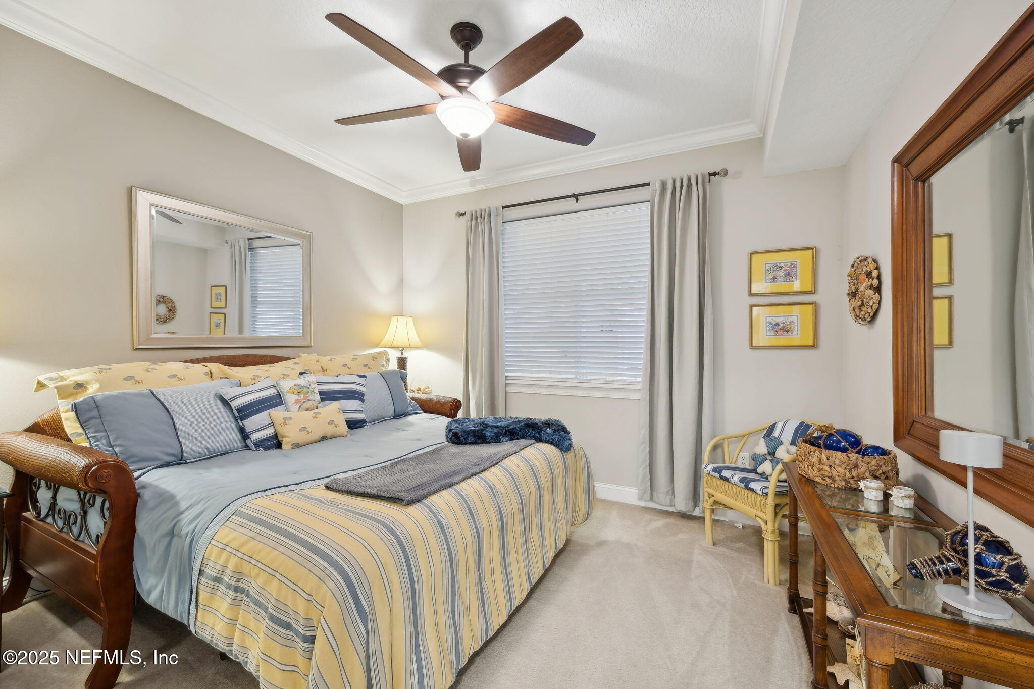 60 Surfview Drive, Unit 801 Palm Coast, FL 32137 - Photo 27 of 64 a bedroom with bed a ceiling fan and a dresser