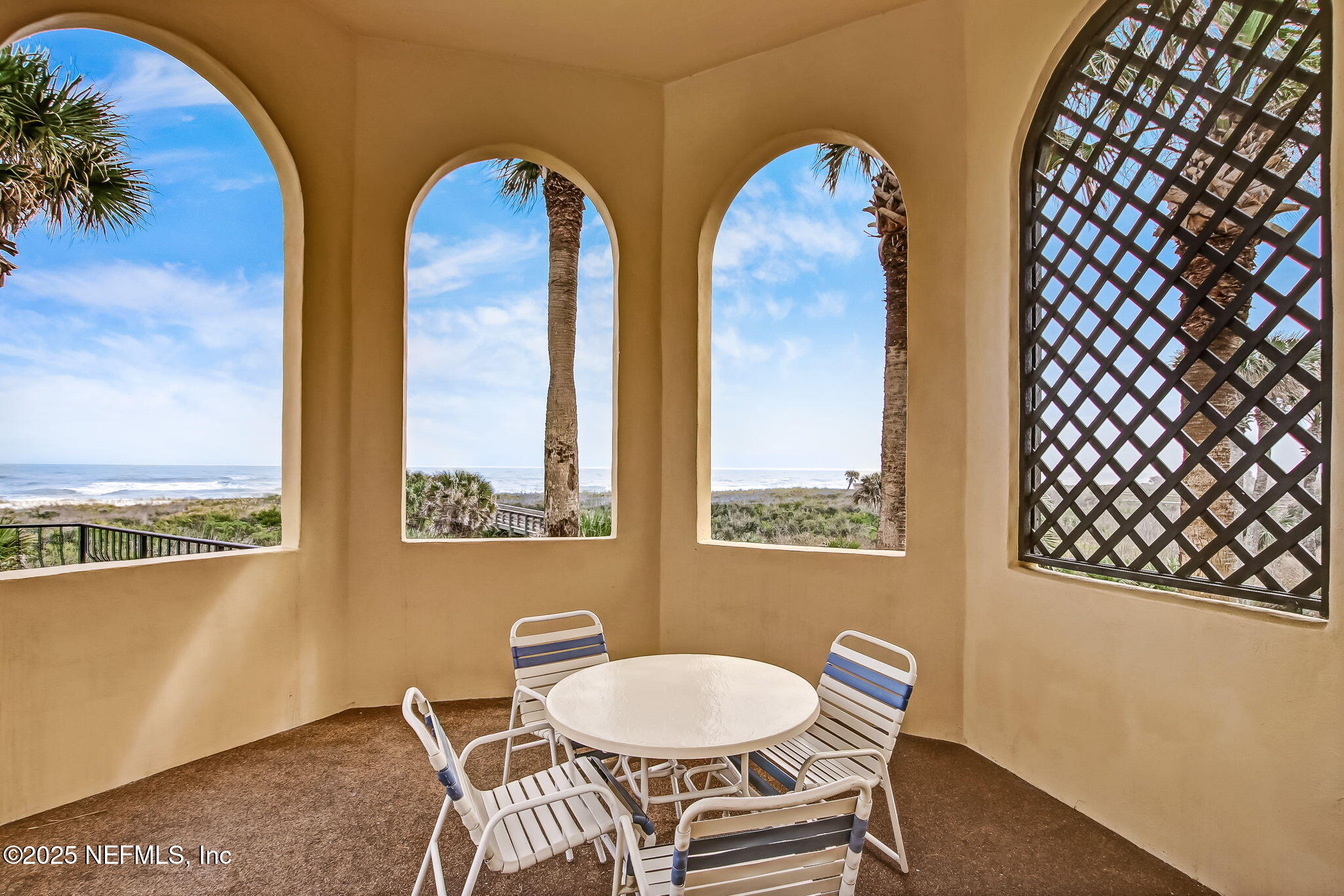 60 Surfview Drive, Unit 801 Palm Coast, FL 32137 - Photo 43 of 64 a view of a dining room with furniture and a floor to ceiling window