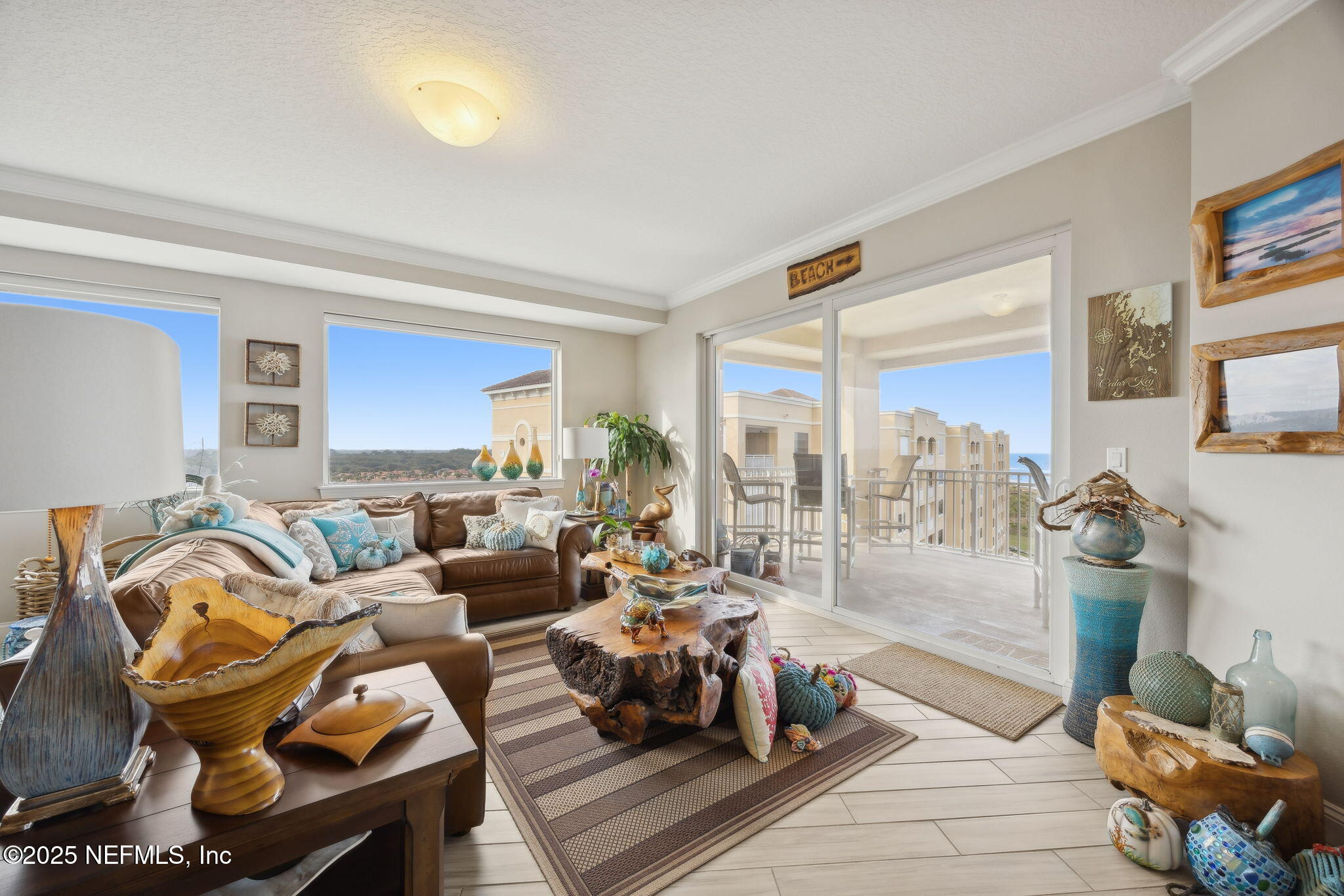 60 Surfview Drive, Unit 801 Palm Coast, FL 32137 - Photo 7 of 64 a living room with furniture and a floor to ceiling window