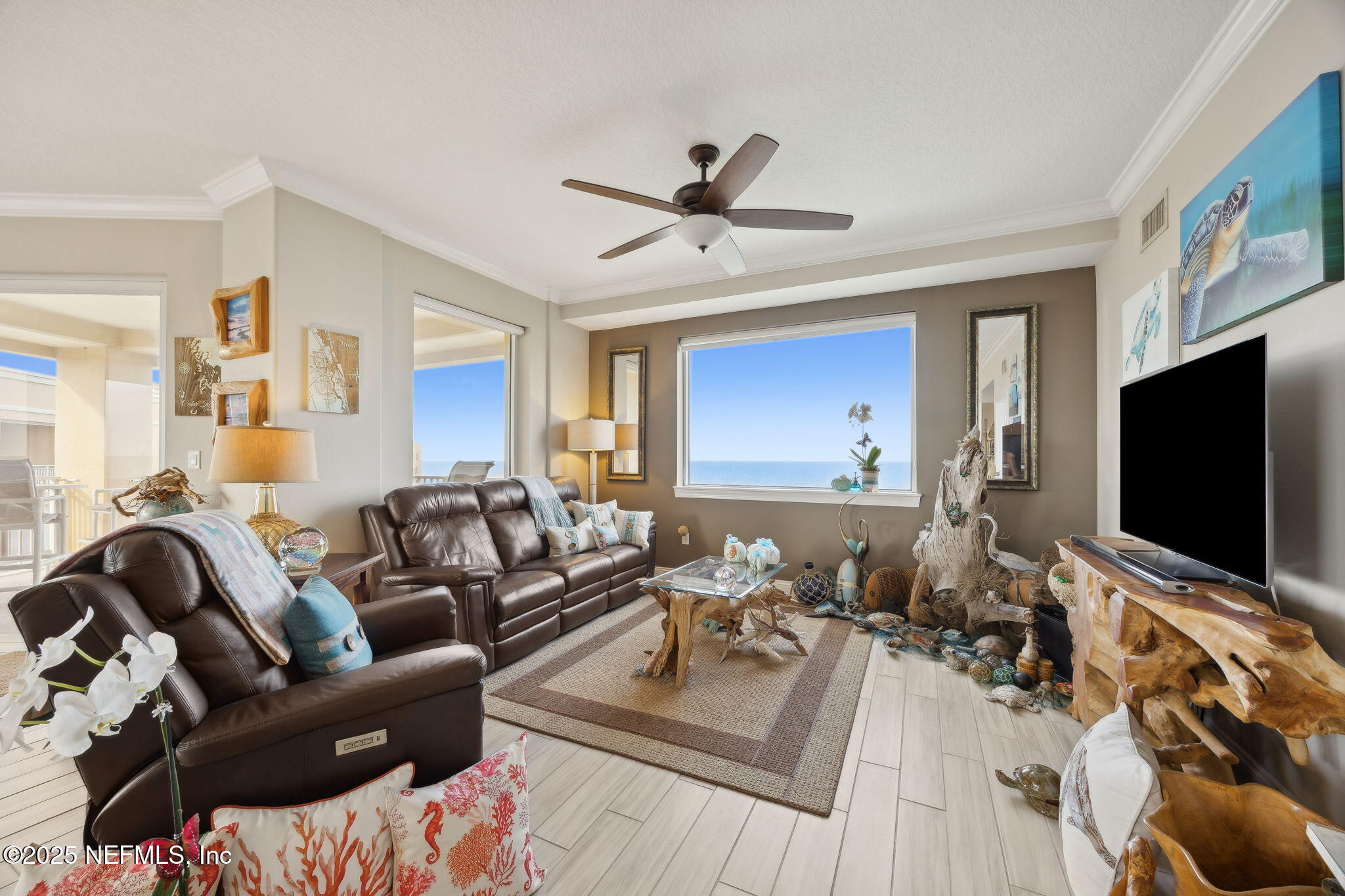 60 Surfview Drive, Unit 801 Palm Coast, FL 32137 - Photo 8 of 64 a living room with furniture and a flat screen tv