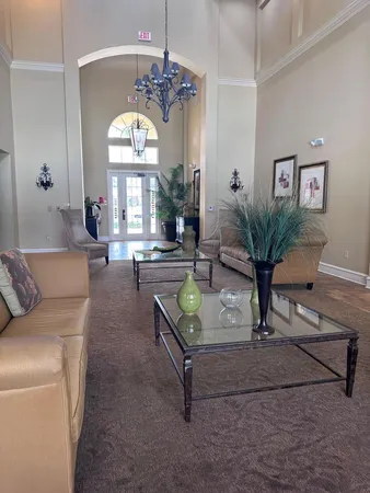 a living room with furniture and a chandelier