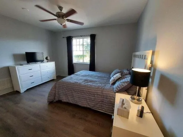 a bedroom with bed and window