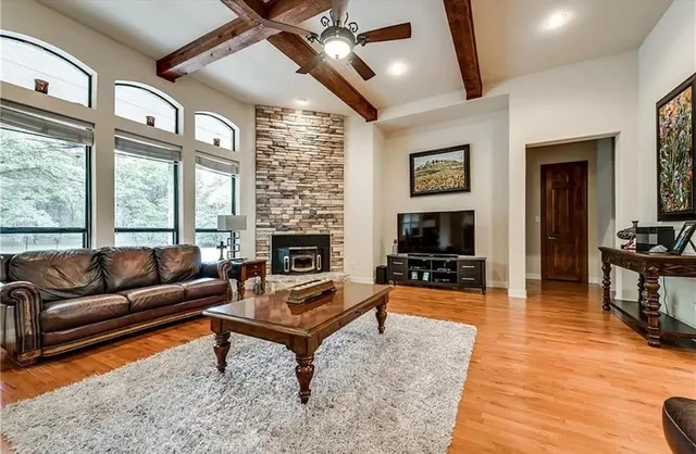 a living room with furniture flat screen tv and a fireplace