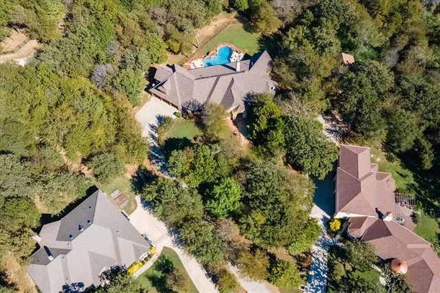 an aerial view of a house with a yard and garden
