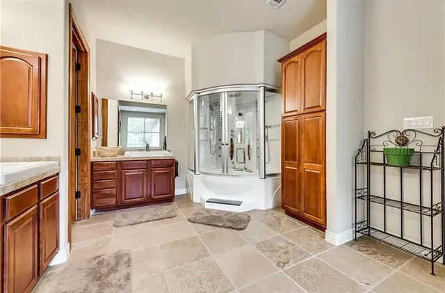 a bathroom with a tub shower and sink