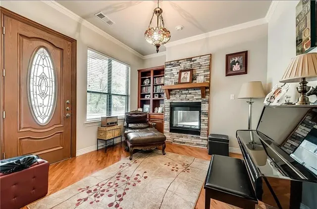 a living room with furniture a fireplace and a flat screen tv
