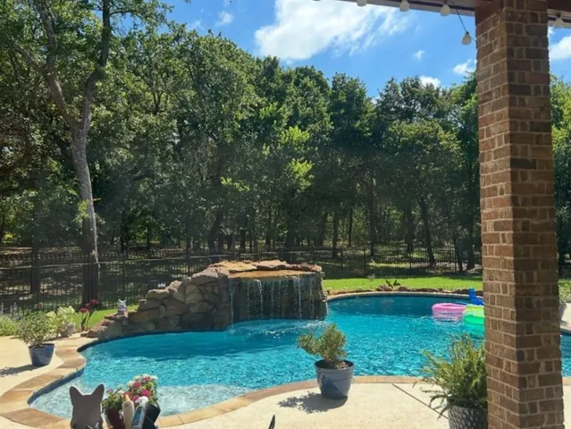 a view of a swimming pool with a patio