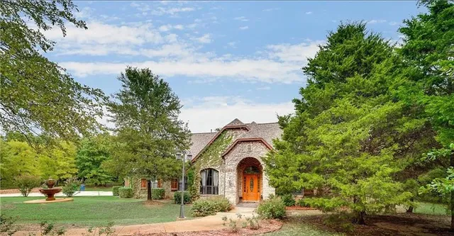 a front view of a house with garden