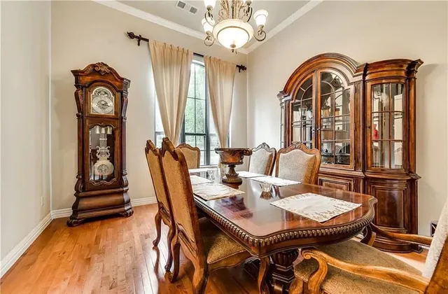 a view of a dining room with furniture wooden floor and a chandelier