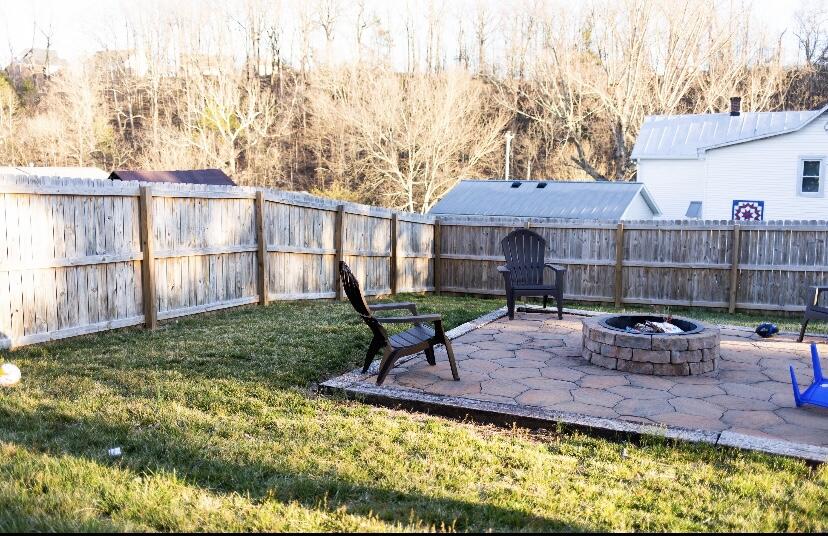 8320 Robin Lynn Road Roanoke, VA 24019 - Photo 17 of 21 a view of a backyard with table and chairs potted plants and large tree