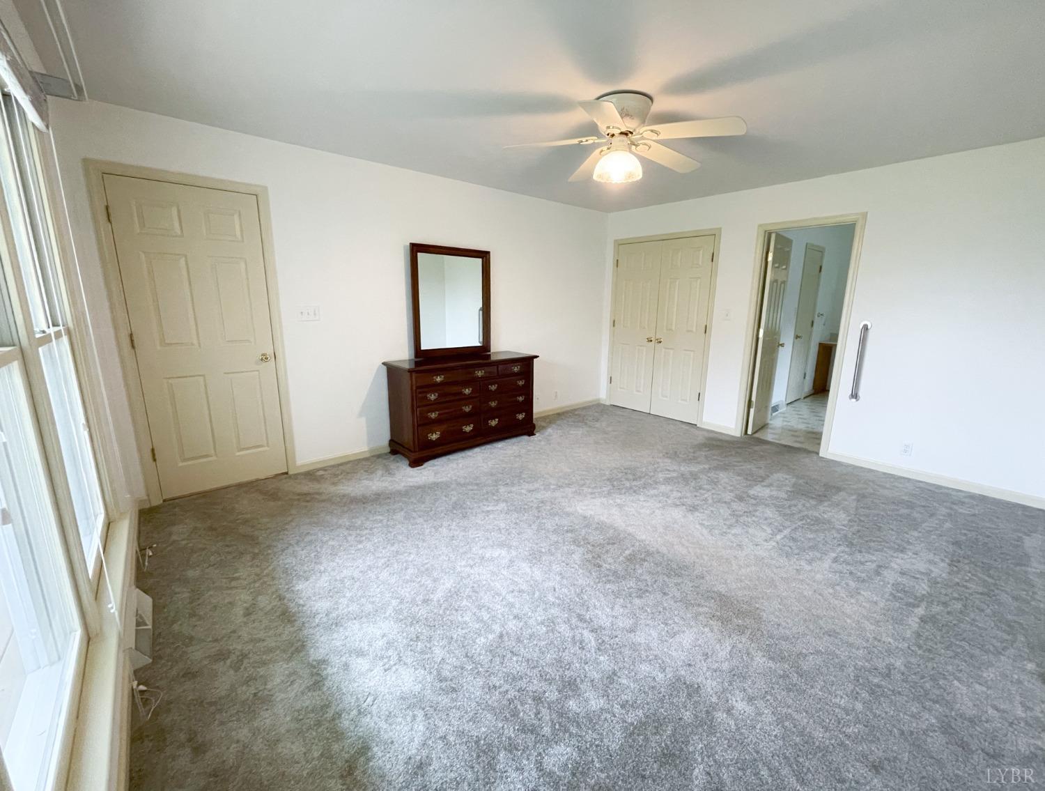 1714 Goode Road Goode, VA 24556 - Photo 8 of 25 an empty room with windows and fan