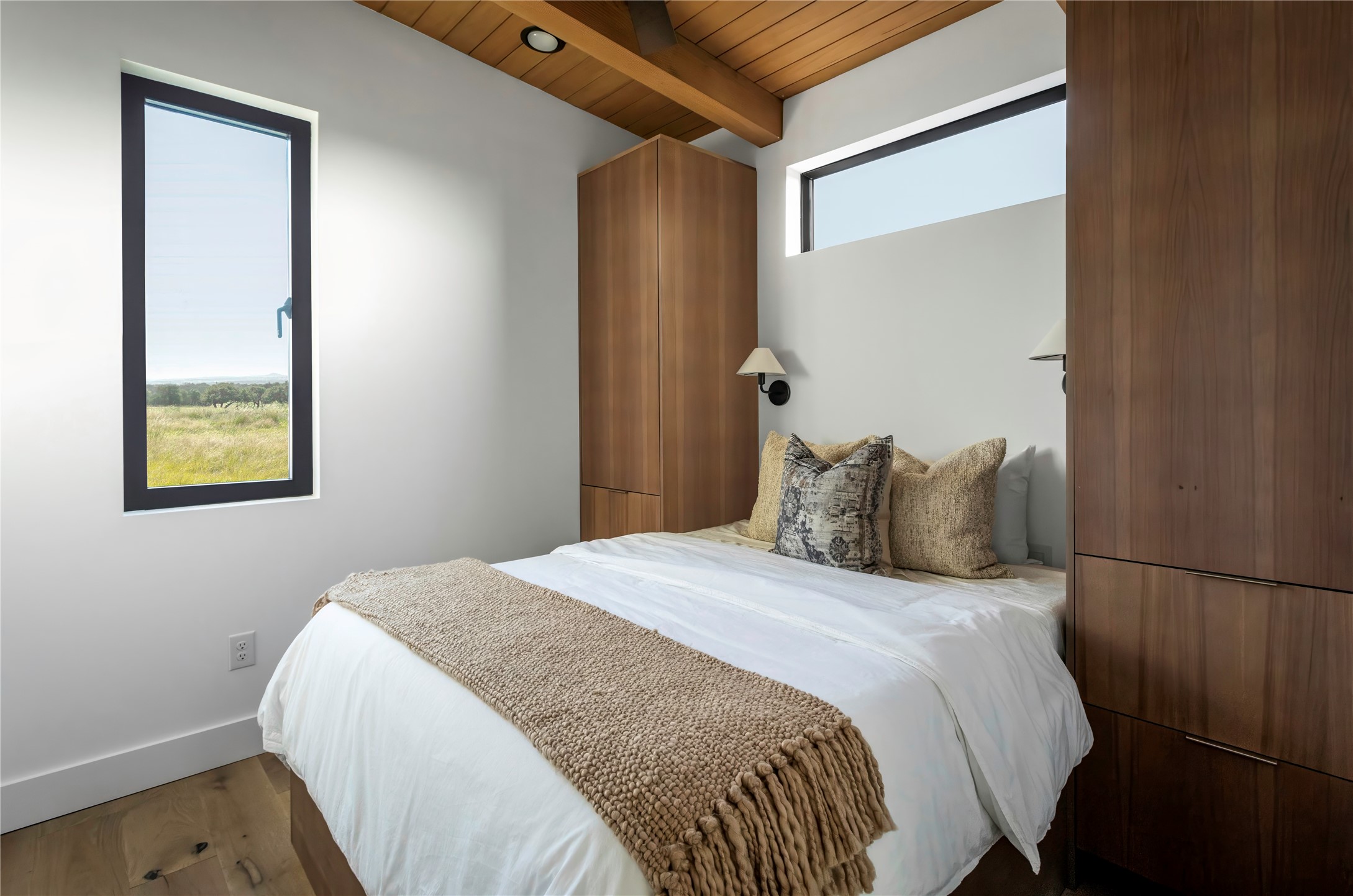 310 Hye Springs Road, Unit 107 Hye, TX 78635 - Photo 9 of 20 Cozy secondary bedroom with custom built-ins, oversized windows, and minimalist modern finishes.