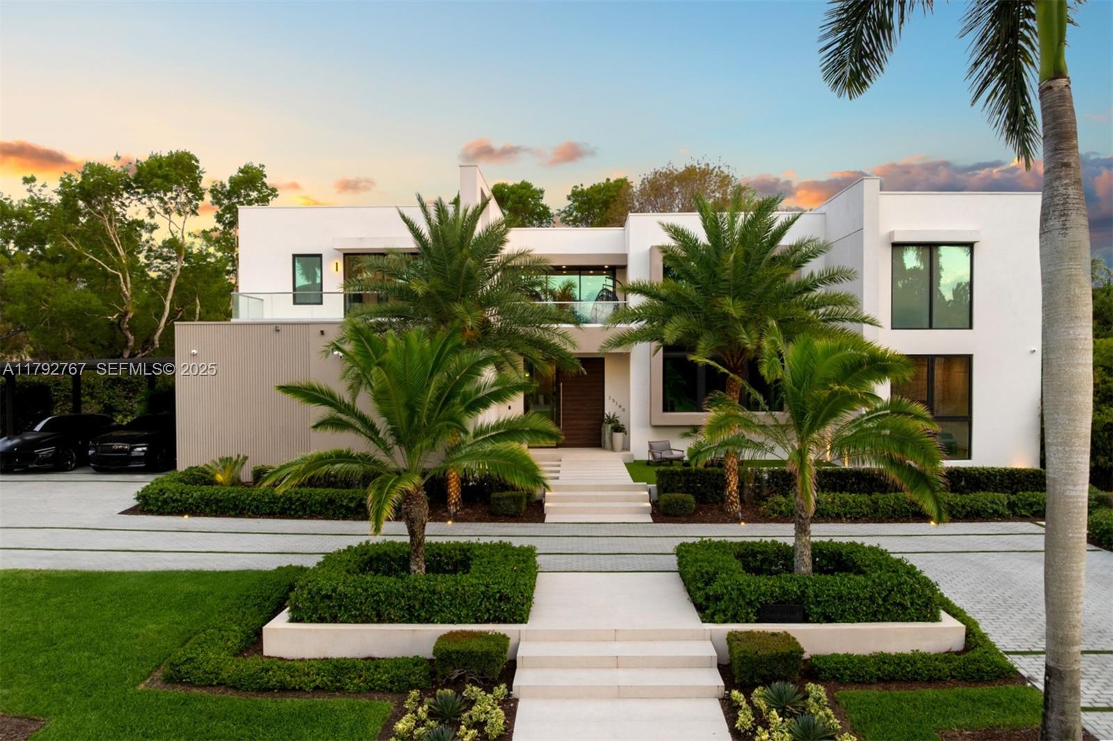 a view of a house with a yard and potted plants