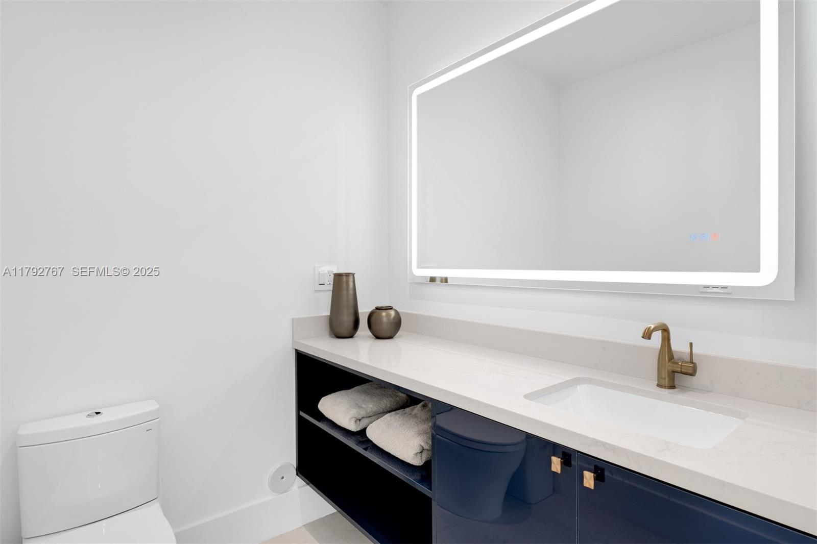 13180 Old Cutler Road Pinecrest, FL 33156 - Photo 15 of 66 a bathroom with a sink and a toilet