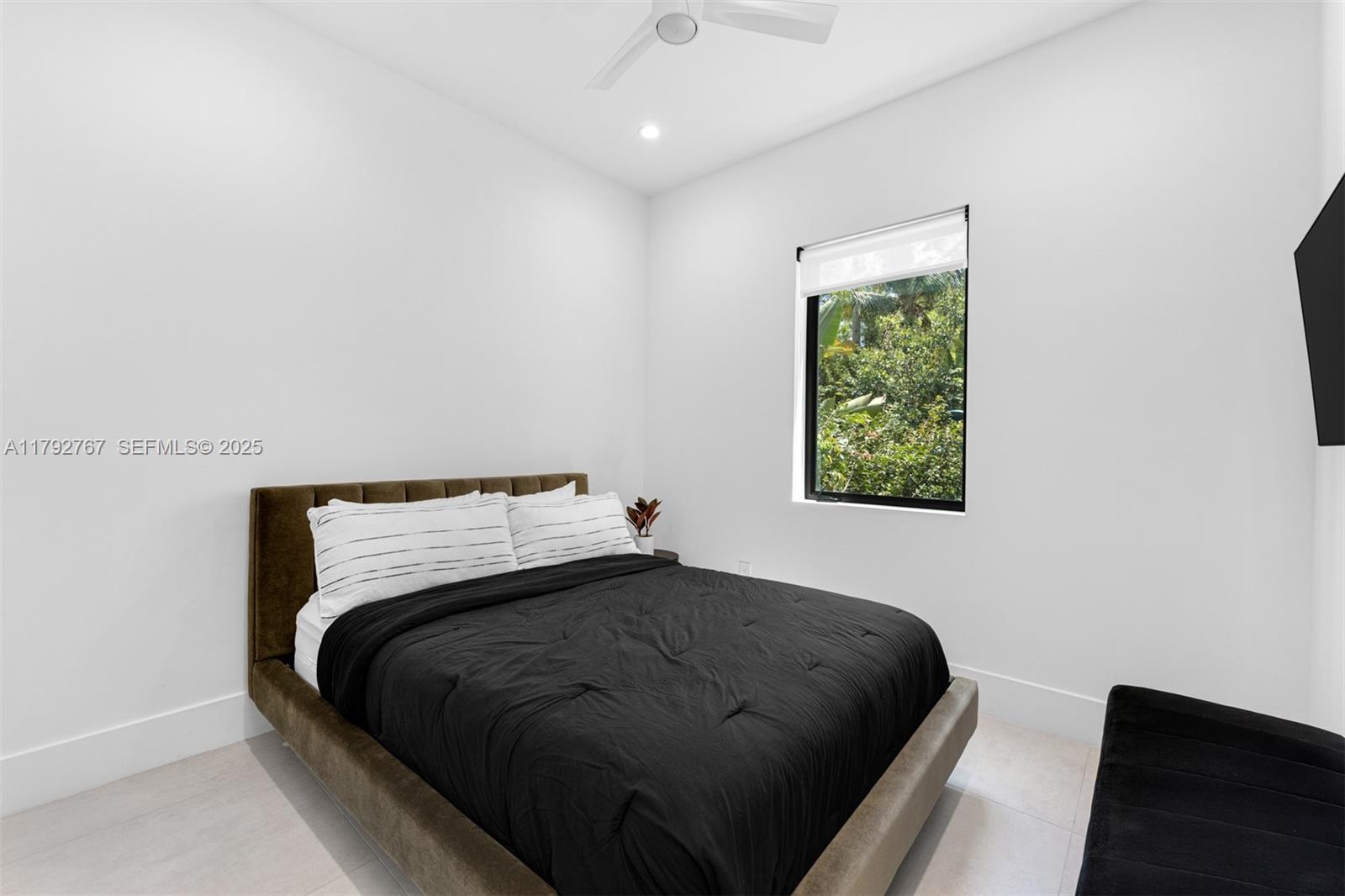 13180 Old Cutler Road Pinecrest, FL 33156 - Photo 23 of 66 a bedroom with a bed and a window