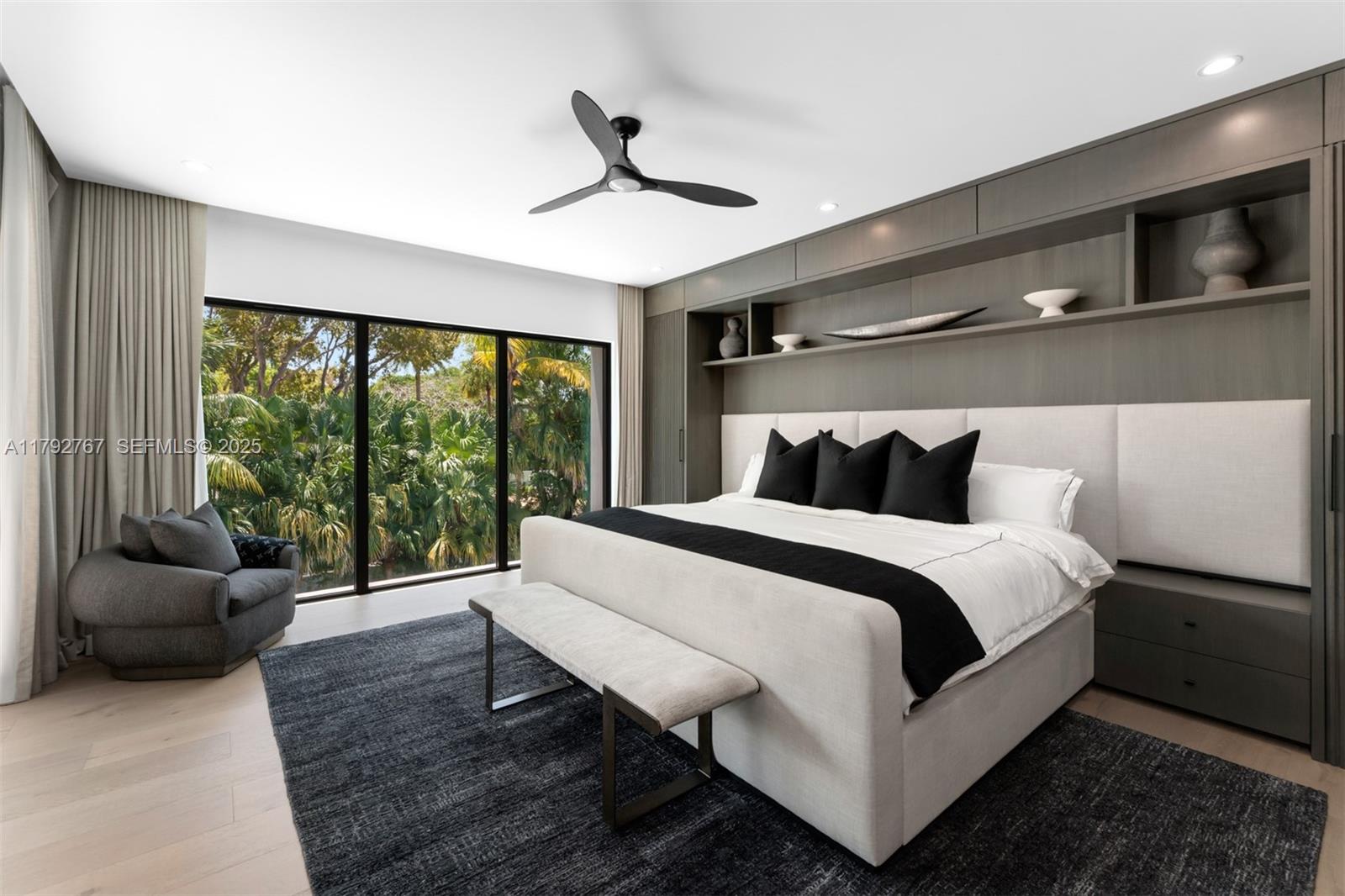 13180 Old Cutler Road Pinecrest, FL 33156 - Photo 28 of 66 a bedroom with a bed and glass window