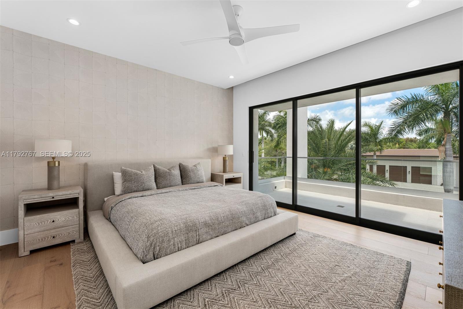 13180 Old Cutler Road Pinecrest, FL 33156 - Photo 32 of 66 a bedroom with a large bed and a large window