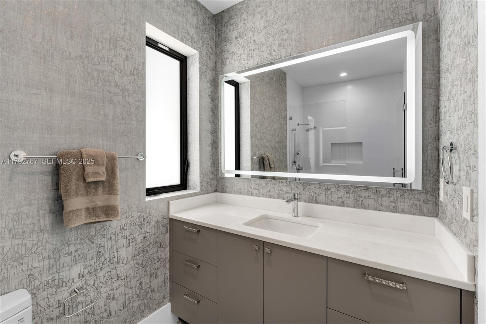 13180 Old Cutler Road Pinecrest, FL 33156 - Photo 35 of 66 a bathroom with a sink and a mirror