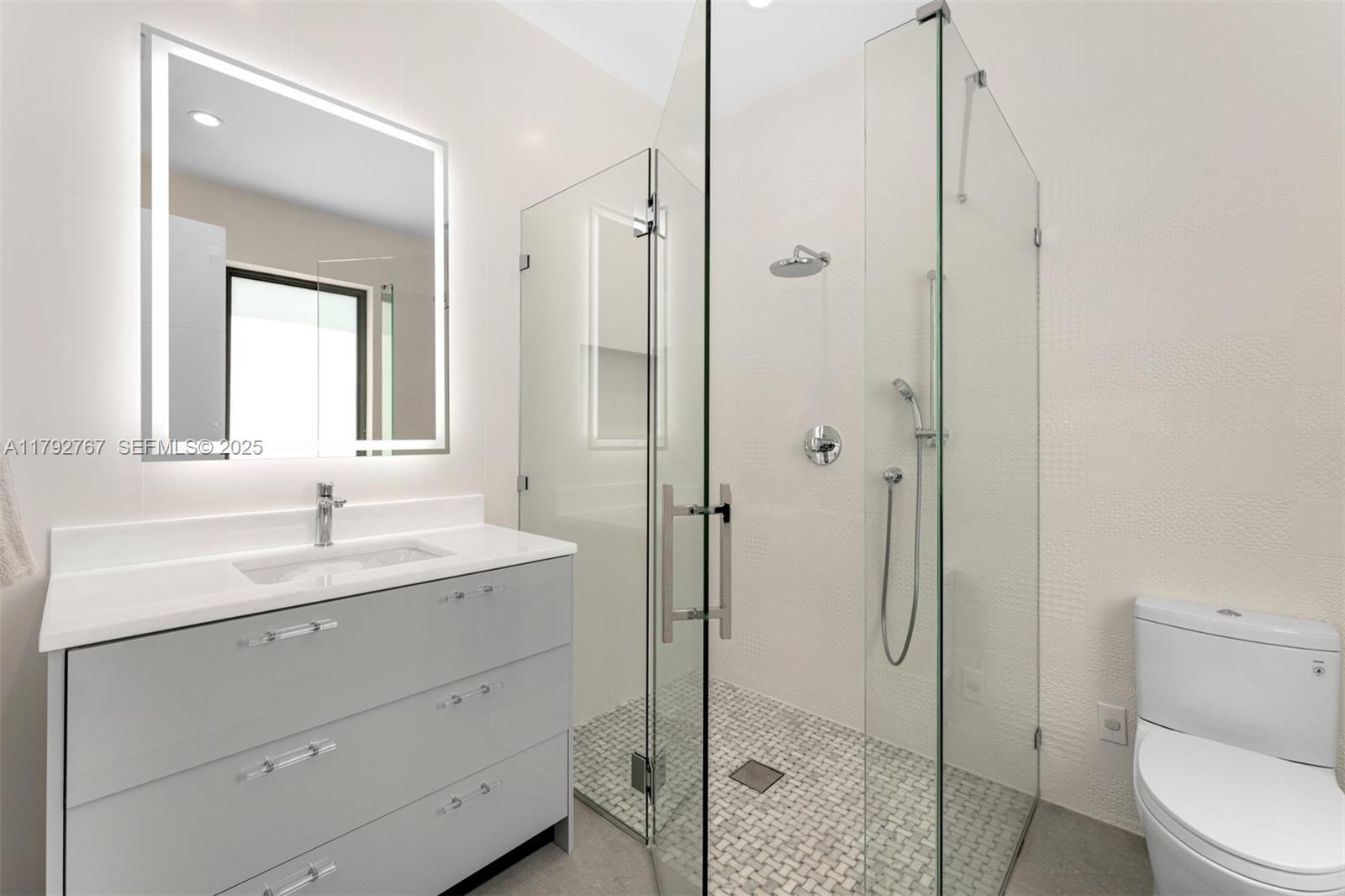 13180 Old Cutler Road Pinecrest, FL 33156 - Photo 37 of 66 a bathroom with a sink toilet and shower