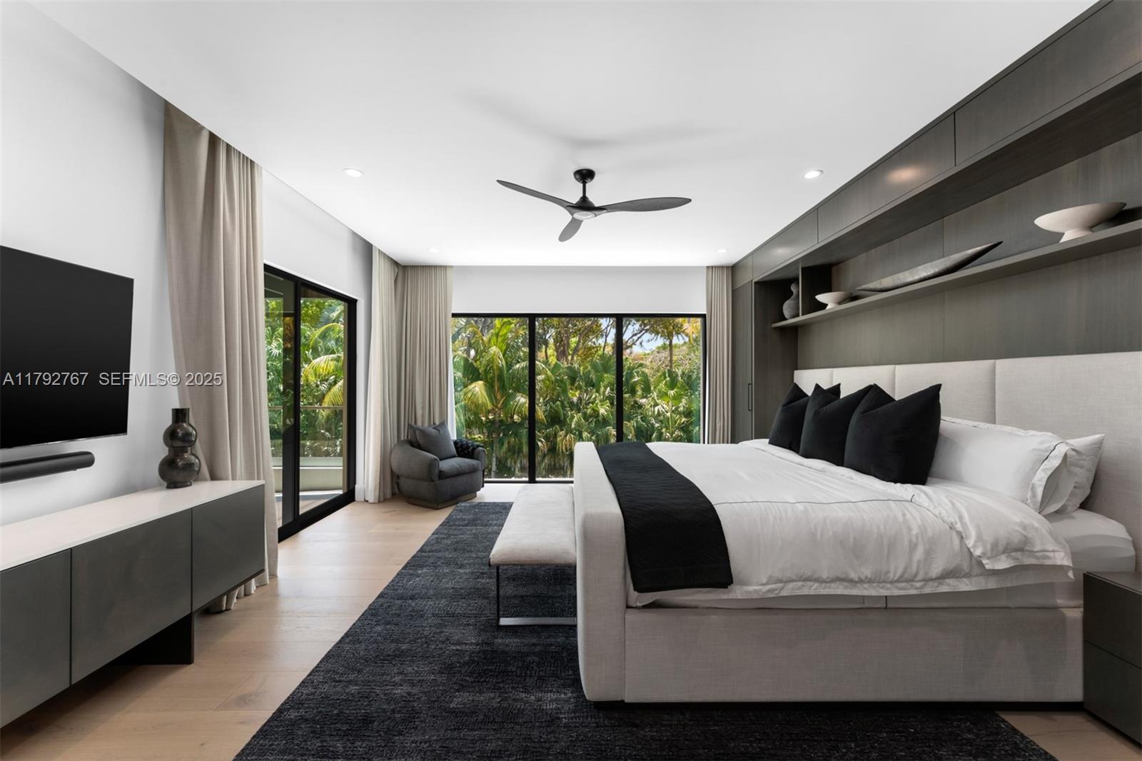 13180 Old Cutler Road Pinecrest, FL 33156 - Photo 5 of 66 a bedroom with a large bed and a flat screen tv