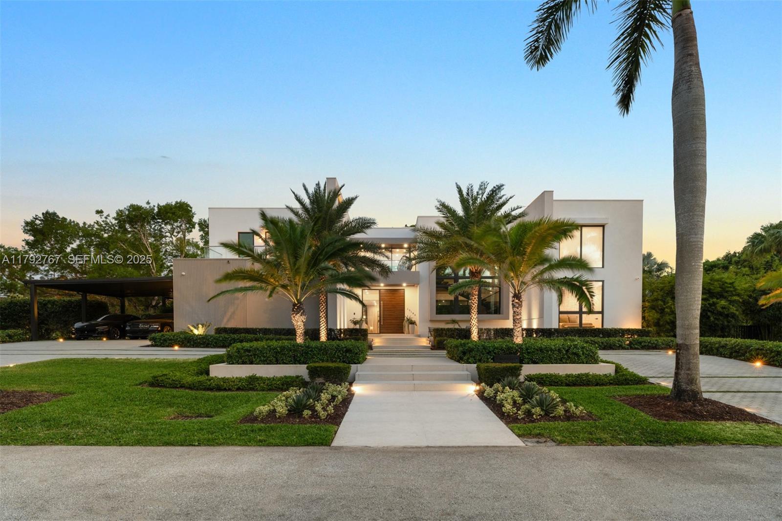 13180 Old Cutler Road Pinecrest, FL 33156 - Photo 56 of 66 a view of a white house with a big yard and palm trees