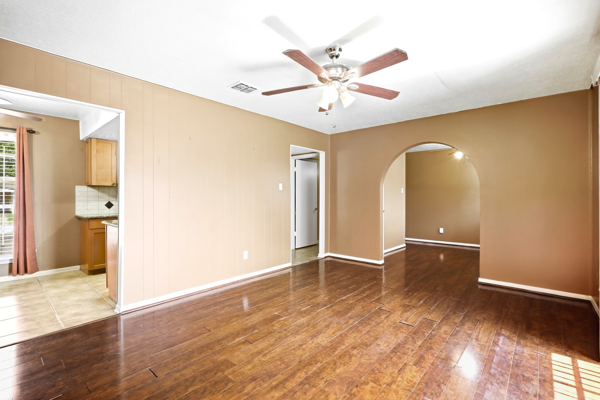 1507 Willow Rock Road Houston, TX 77088 - Photo 11 of 27 Arched openings connect the living room to the kitchen and dining spaces for an easy, open flow.